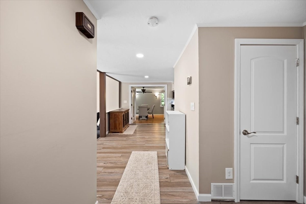 115 Douglas Road Webster, MA 01570 - Photo 10 of 42 a hallway with a wooden floor and a bathroom