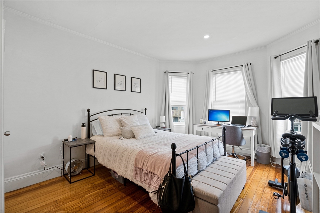 a bedroom with double bed and a window