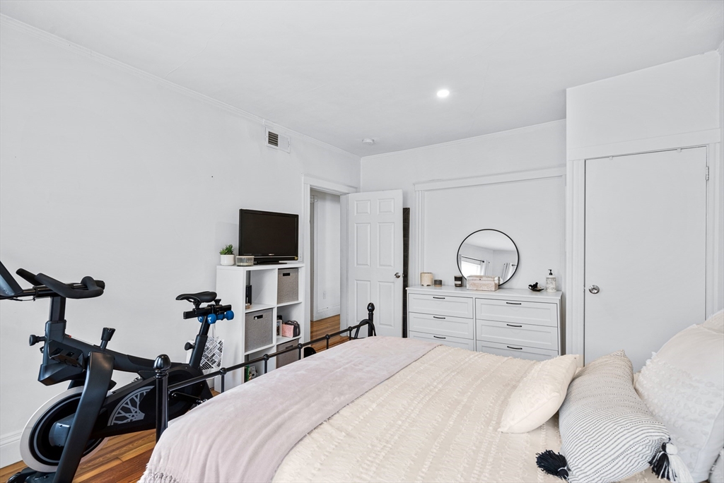 7 Hallam Street, Unit 3 Boston, MA 02125 - Photo 2 of 12 a bedroom with a bed and a flat screen tv