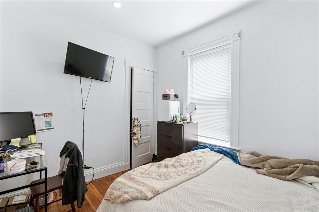 7 Hallam Street, Unit 3 Boston, MA 02125 - Photo 3 of 12 a bedroom with a bed and a flat screen tv