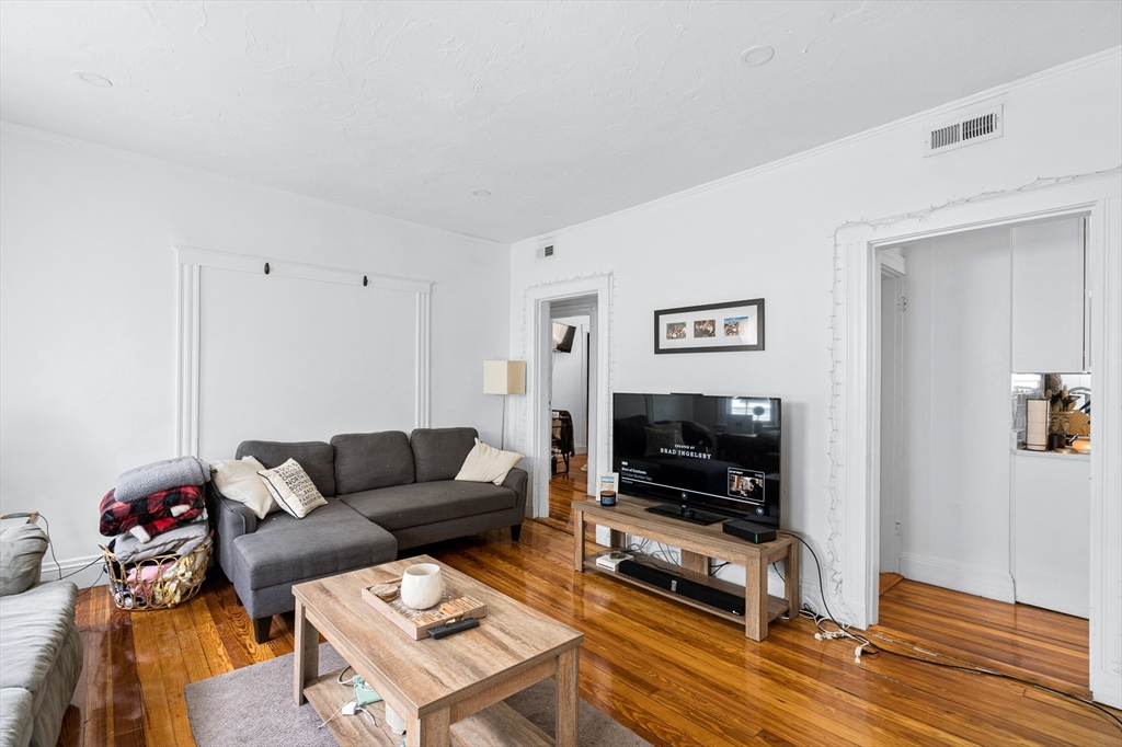 7 Hallam Street, Unit 3 Boston, MA 02125 - Photo 5 of 12 a living room with furniture and a flat screen tv