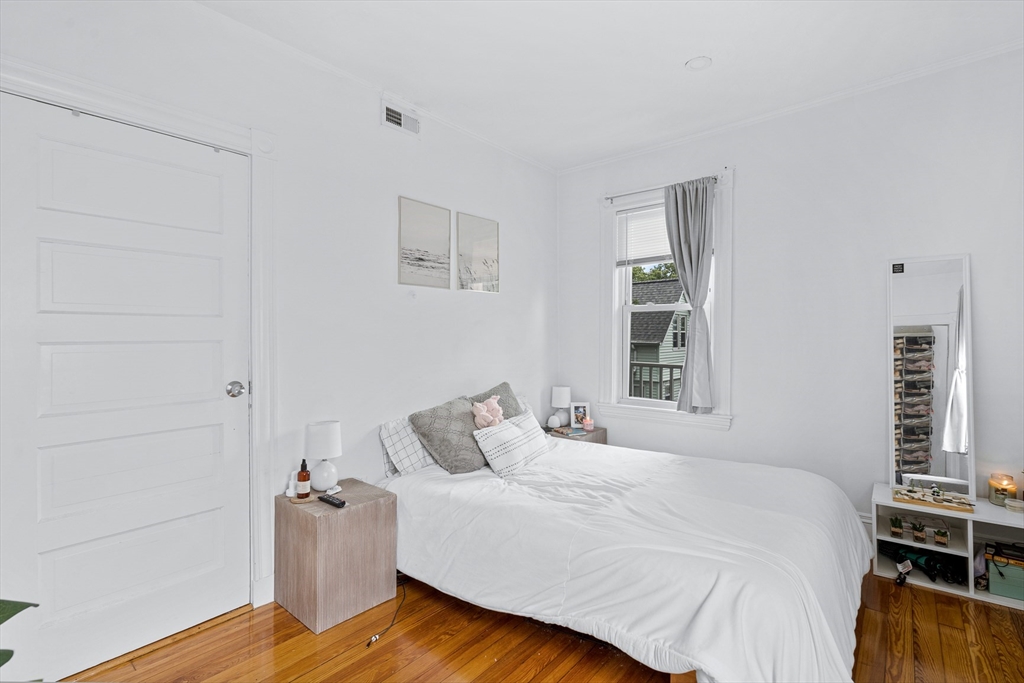 7 Hallam Street, Unit 3 Boston, MA 02125 - Photo 6 of 12 a bedroom with a bed and wooden floor