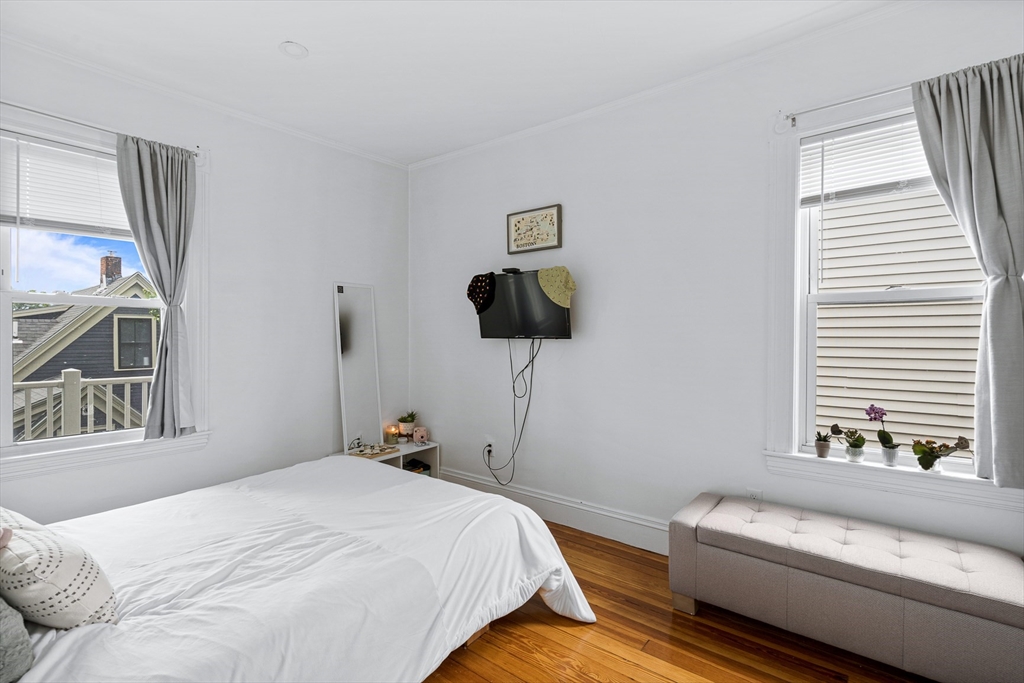 7 Hallam Street, Unit 3 Boston, MA 02125 - Photo 7 of 12 a bedroom with a bed and window