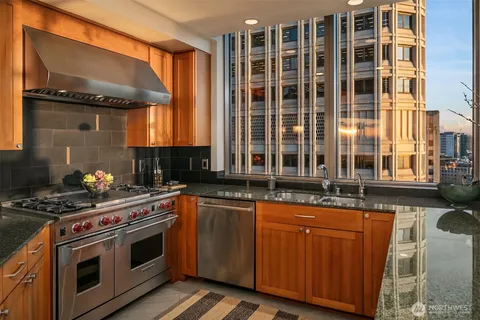 a kitchen with granite countertop a stove and a sink