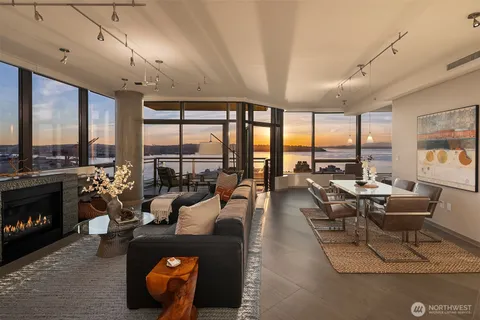 a living room with furniture and a floor to ceiling window