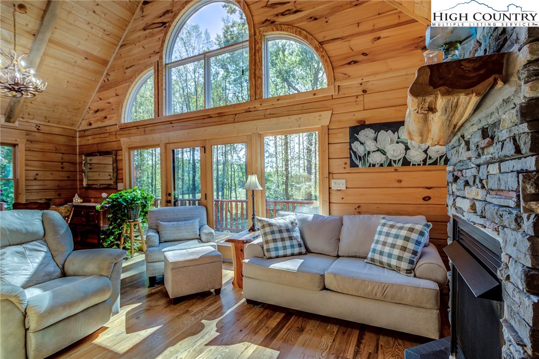 3460 South Center Church Road Thurmond, NC 28683 - Photo 36 of 50 a living room with furniture a fireplace and a large window