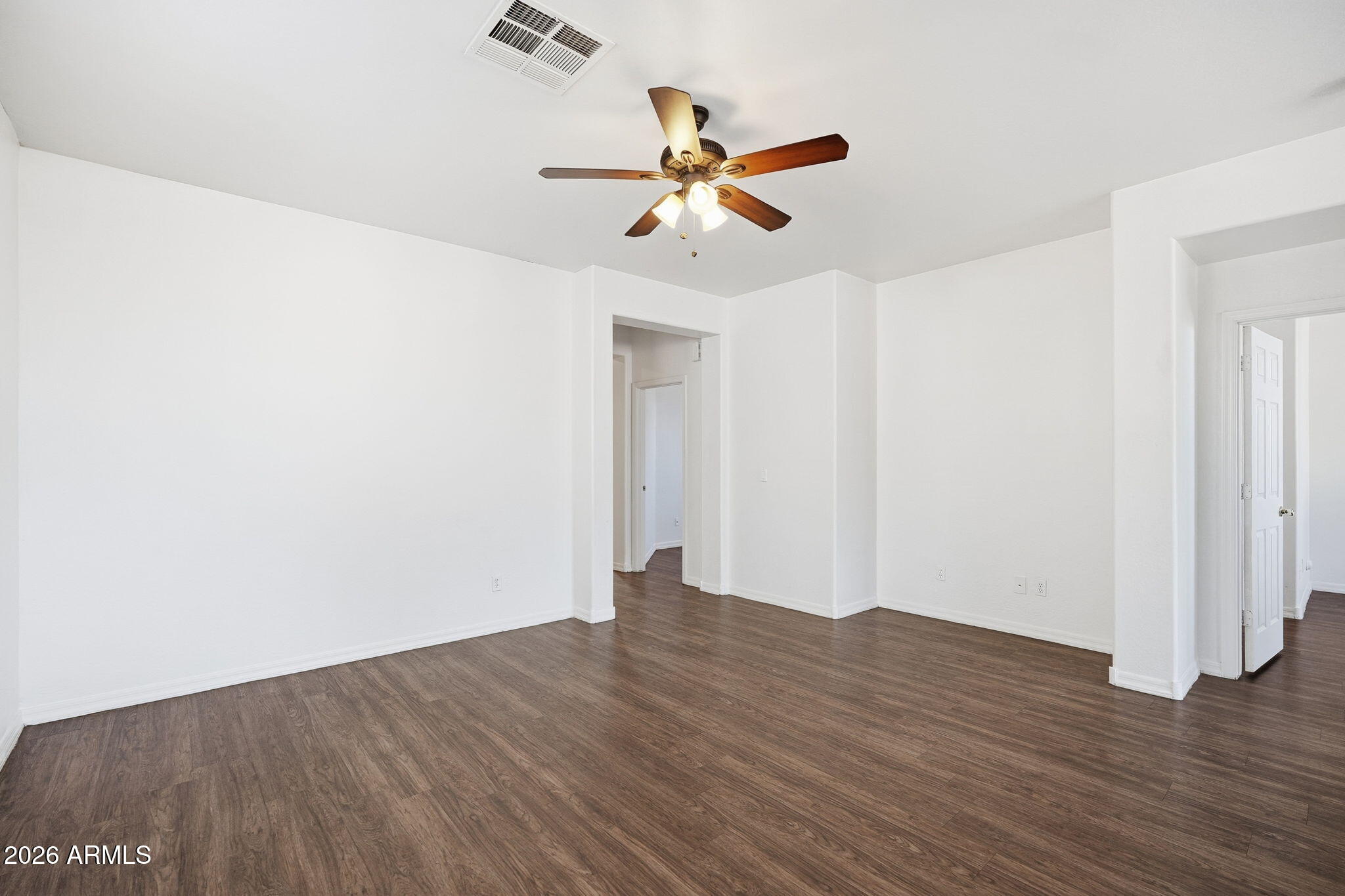 9360 West Payson Road Tolleson, AZ 85353 - Photo 17 of 33 a view of empty room with wooden floor