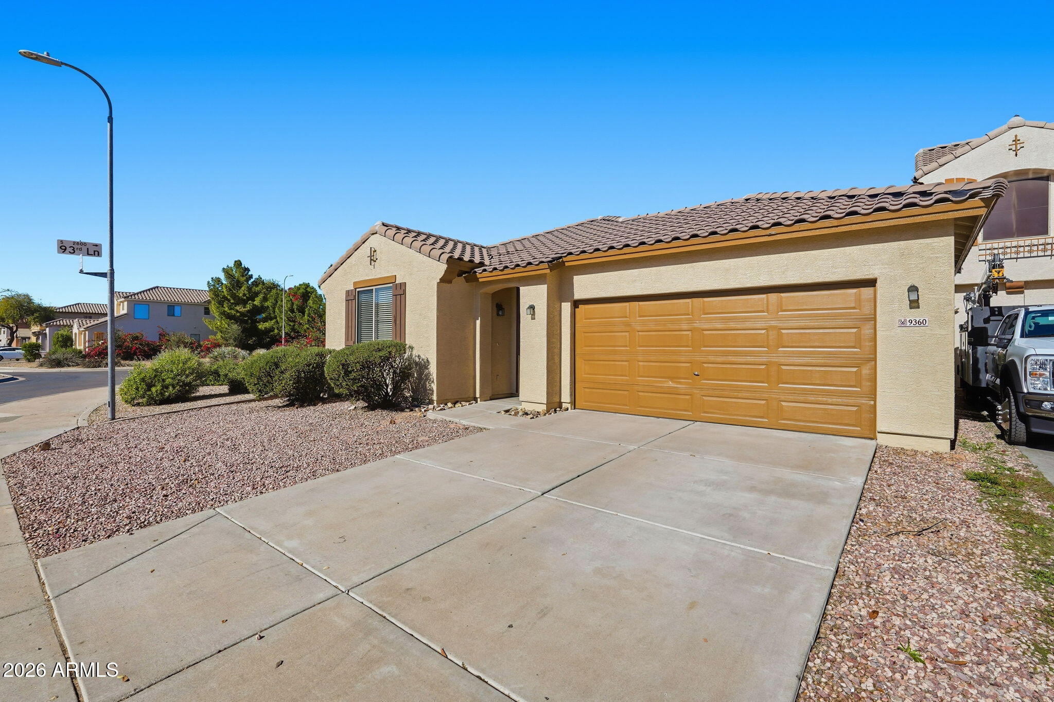 9360 West Payson Road Tolleson, AZ 85353 - Photo 2 of 33 a front view of a house with a yard and garage