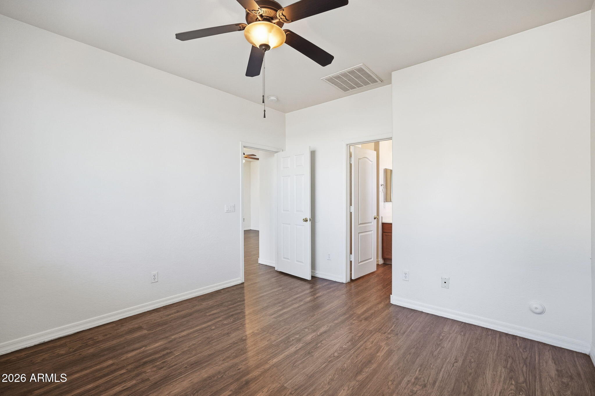 9360 West Payson Road Tolleson, AZ 85353 - Photo 21 of 33 a view of an empty room with wooden floor