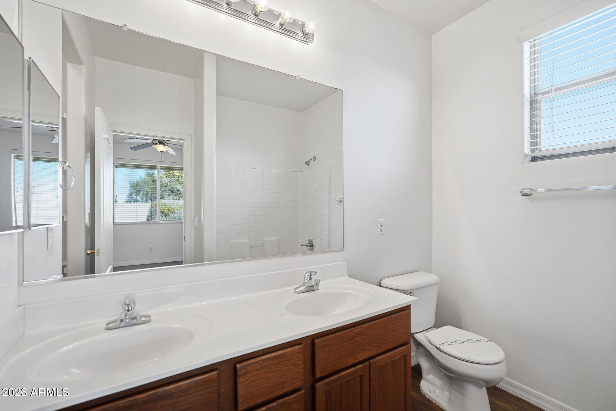 9360 West Payson Road Tolleson, AZ 85353 - Photo 27 of 33 a bathroom with a sink toilet and a mirror