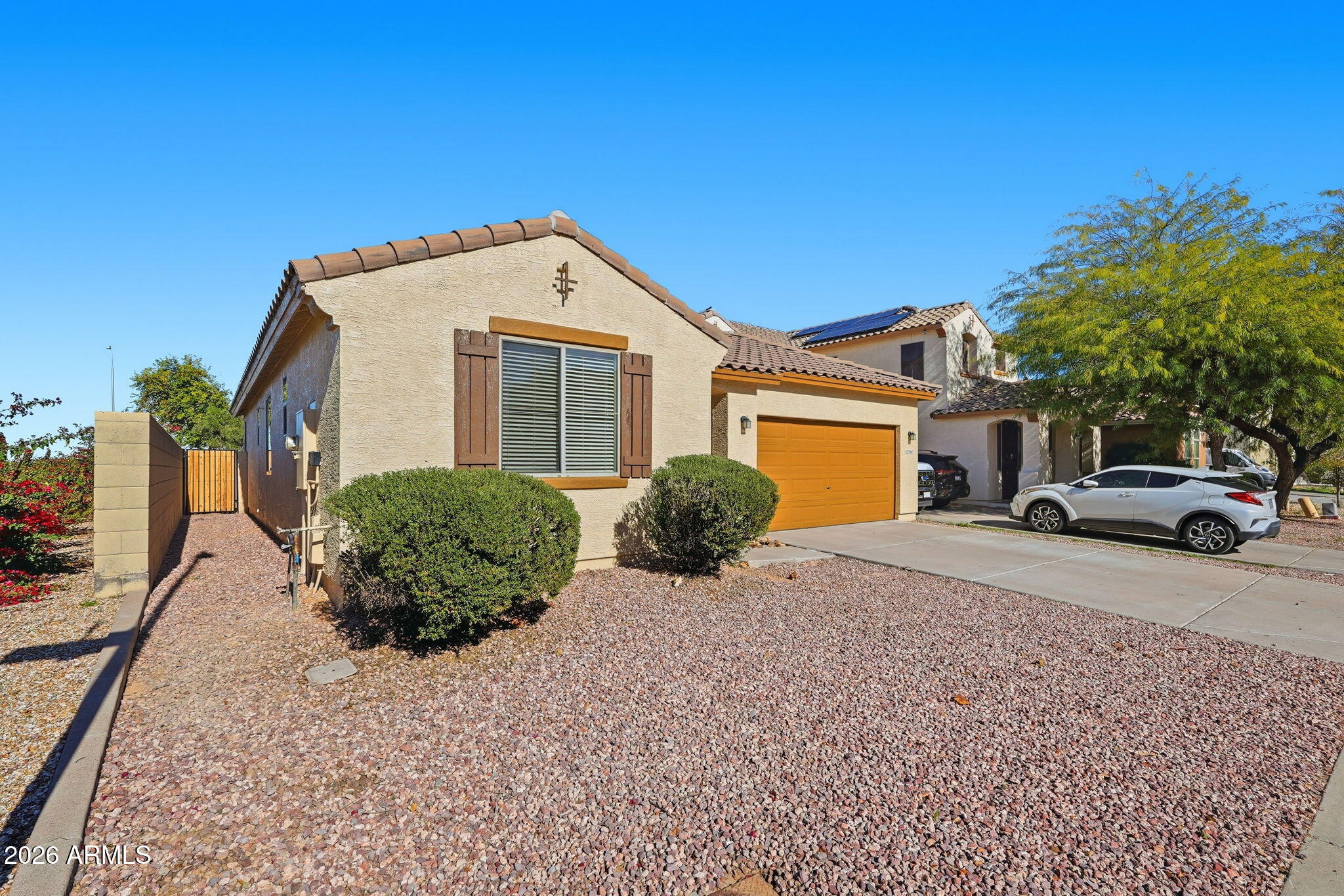 9360 West Payson Road Tolleson, AZ 85353 - Photo 3 of 33 a front view of a house with a yard and garage