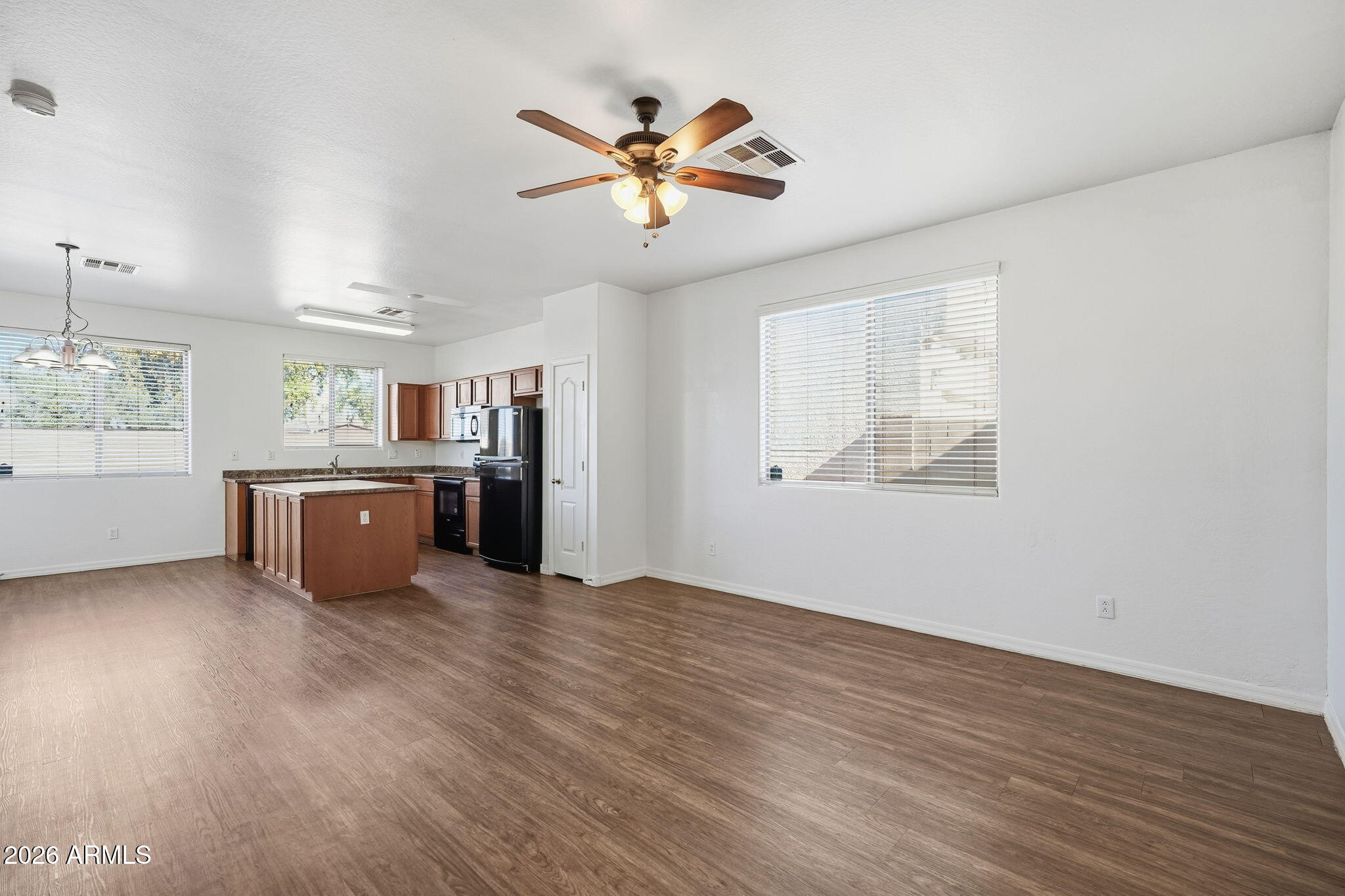 9360 West Payson Road Tolleson, AZ 85353 - Photo 6 of 33 a view of a kitchen with a stove wooden cabinets and window