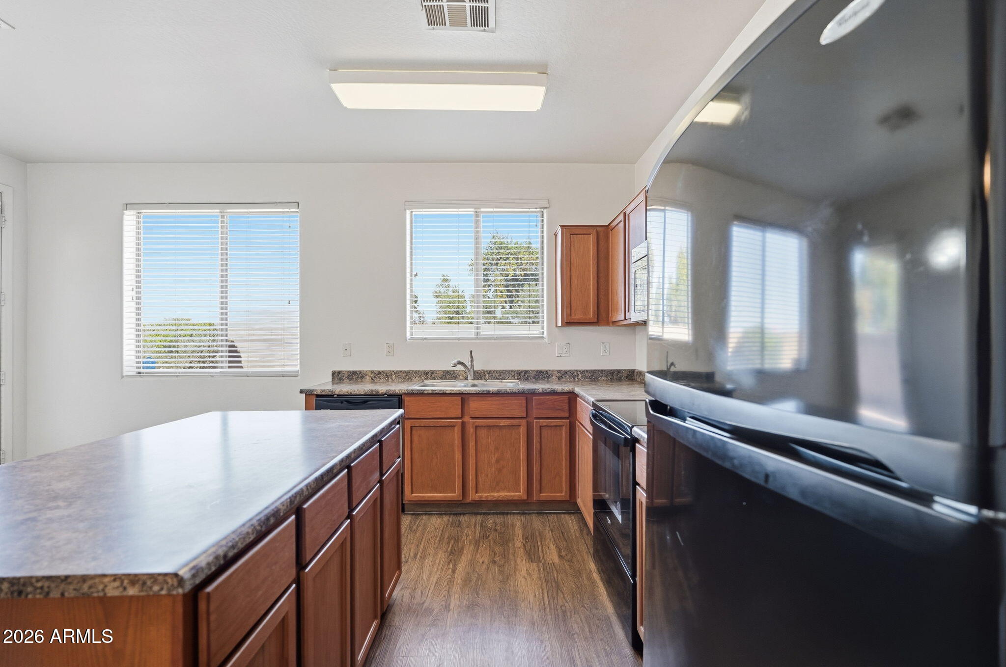 9360 West Payson Road Tolleson, AZ 85353 - Photo 9 of 33 a kitchen with stainless steel appliances granite countertop a sink stove and cabinets