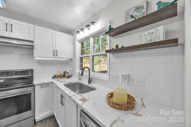 a kitchen with a sink cabinets and a stove