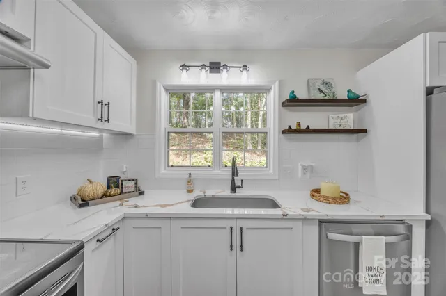 a kitchen with a sink cabinets and window