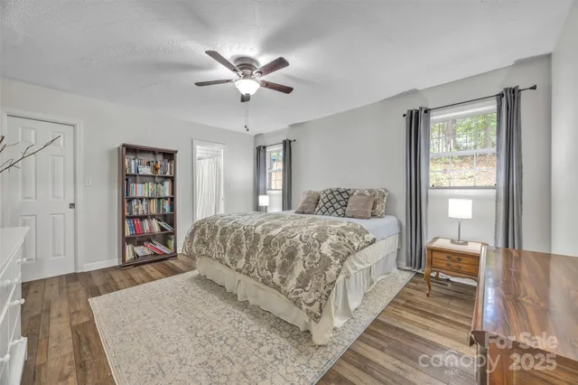 a spacious bedroom with a large bed and a chandelier