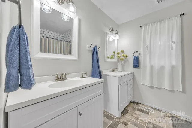 a bathroom with a sink double vanity and a mirror