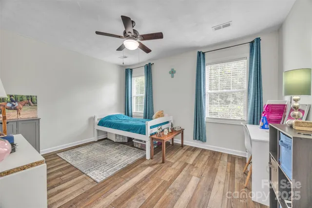a living room with a baby crib furniture and a window