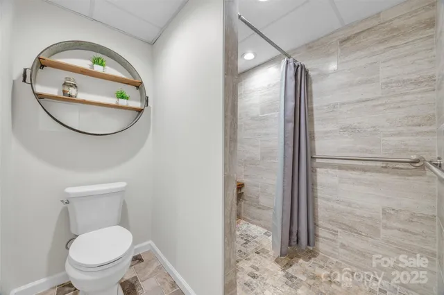 a bathroom with a toilet and a mirror