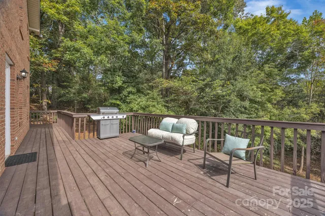 a balcony with wooden floor table and chairs