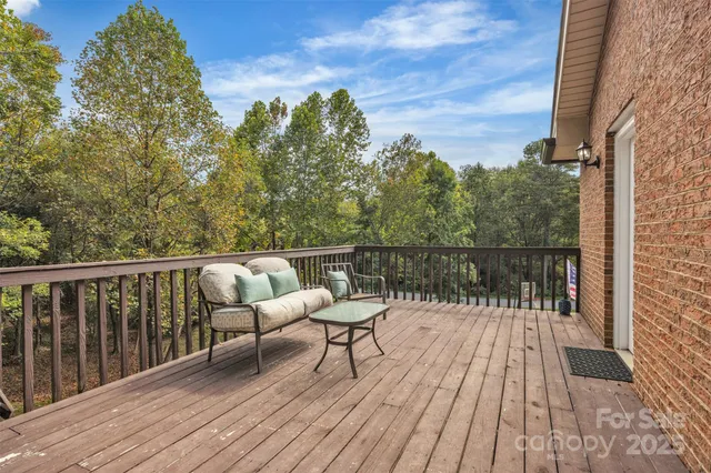 a balcony with wooden floor and fence