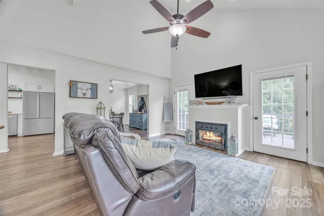 a living room with furniture a fireplace and a flat screen tv