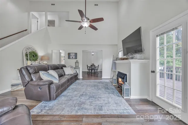 a living room with furniture a fireplace and a flat screen tv