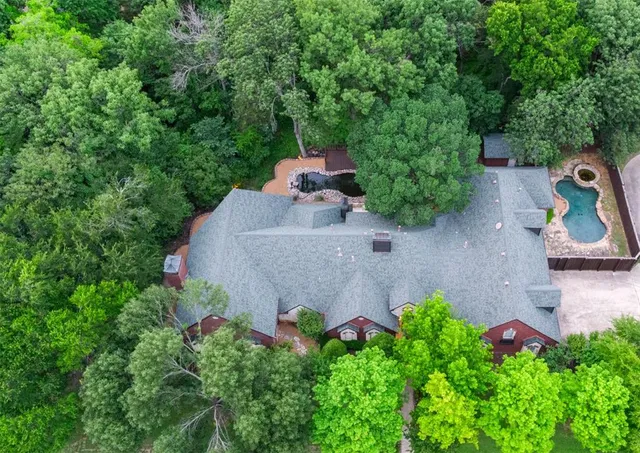 front view of a house with a yard and potted plants