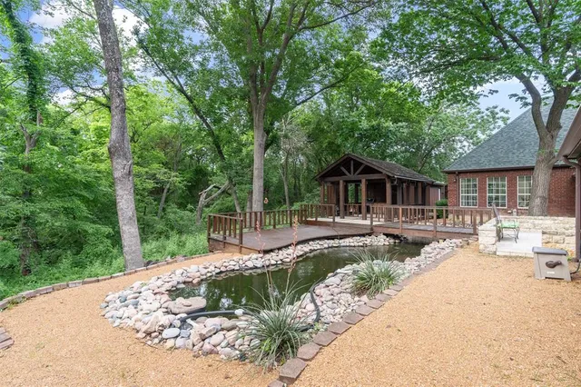 a view of a house with backyard sitting area and garden