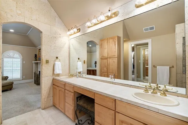 a spacious bathroom with a sink double vanity and a mirror