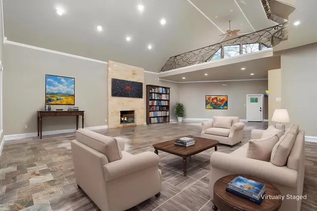a living room with furniture a fireplace and a flat screen tv