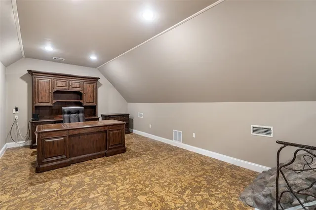 a kitchen with granite countertop a refrigerator and a stove top oven