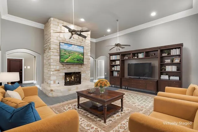 a living room with furniture a flat screen tv and a fireplace