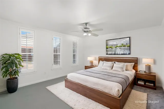 a bedroom with bed and a potted plant