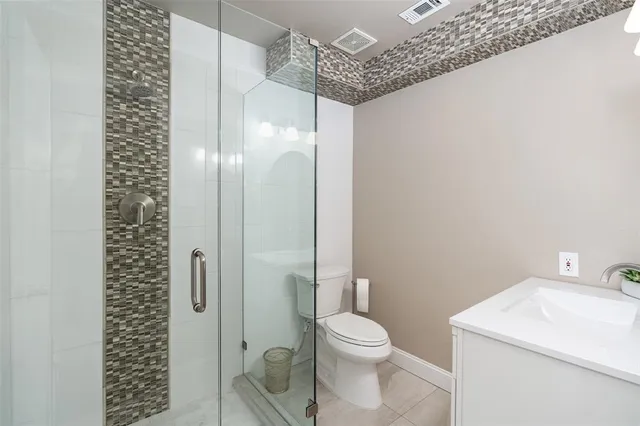 a bathroom with a shower a toilet and a sink