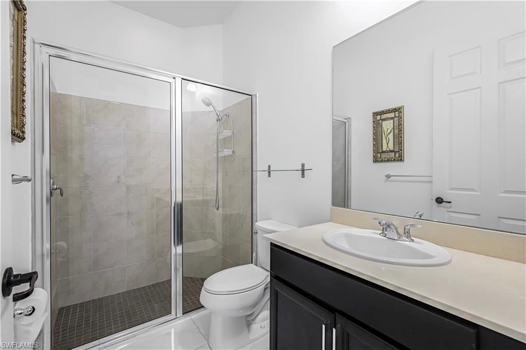 4761 Rosetta Terrace Ave Maria, FL 34142 - Photo 11 of 35 a bathroom with a granite countertop sink toilet and shower