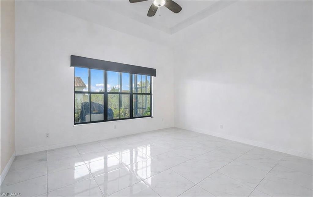 4761 Rosetta Terrace Ave Maria, FL 34142 - Photo 12 of 35 an empty room with windows and ceiling fan