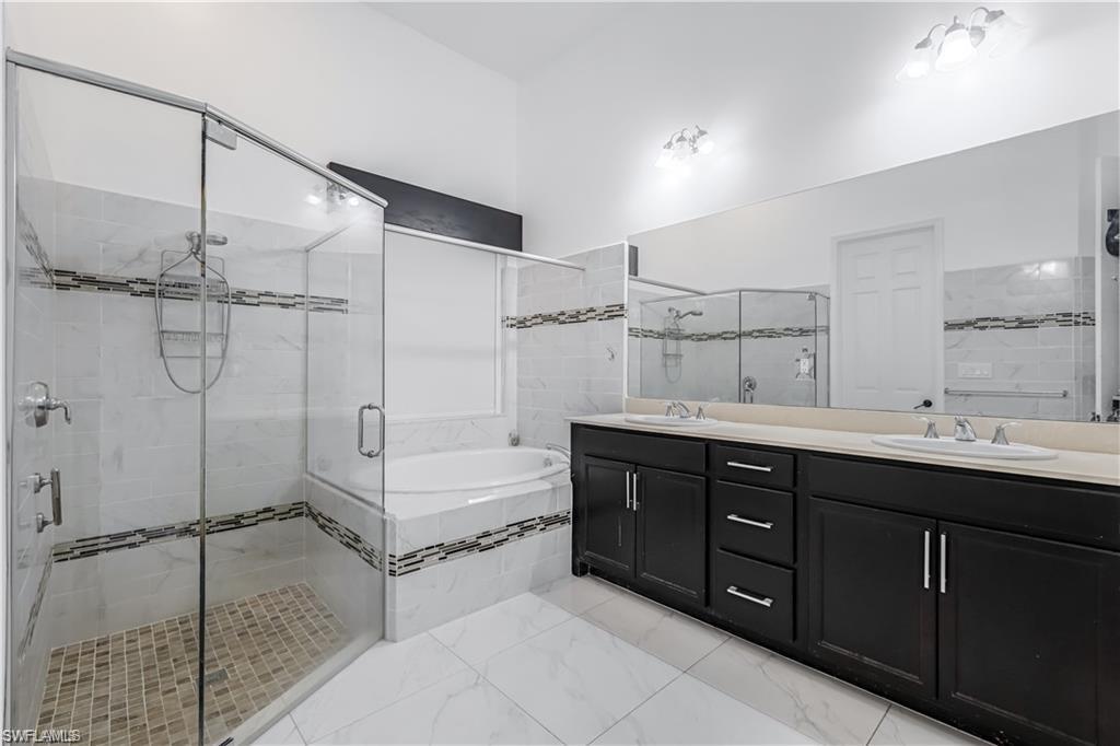 4761 Rosetta Terrace Ave Maria, FL 34142 - Photo 9 of 35 a bathroom with a double vanity sink mirror double and shower