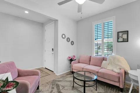 a living room with furniture a chandelier and a window