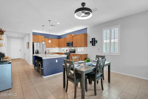 a kitchen with a dining table chairs and microwave