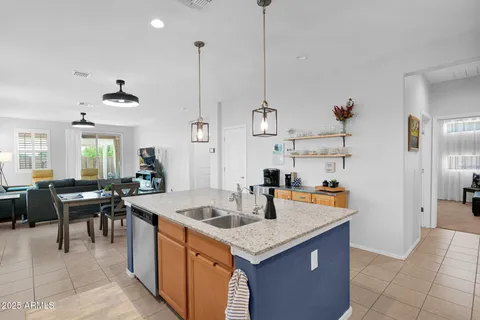 a kitchen with sink cabinets and living room view