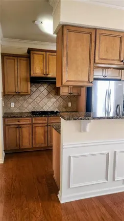 a kitchen with a sink cabinets and a wooden floor