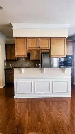 a kitchen with granite countertop a stove and a sink
