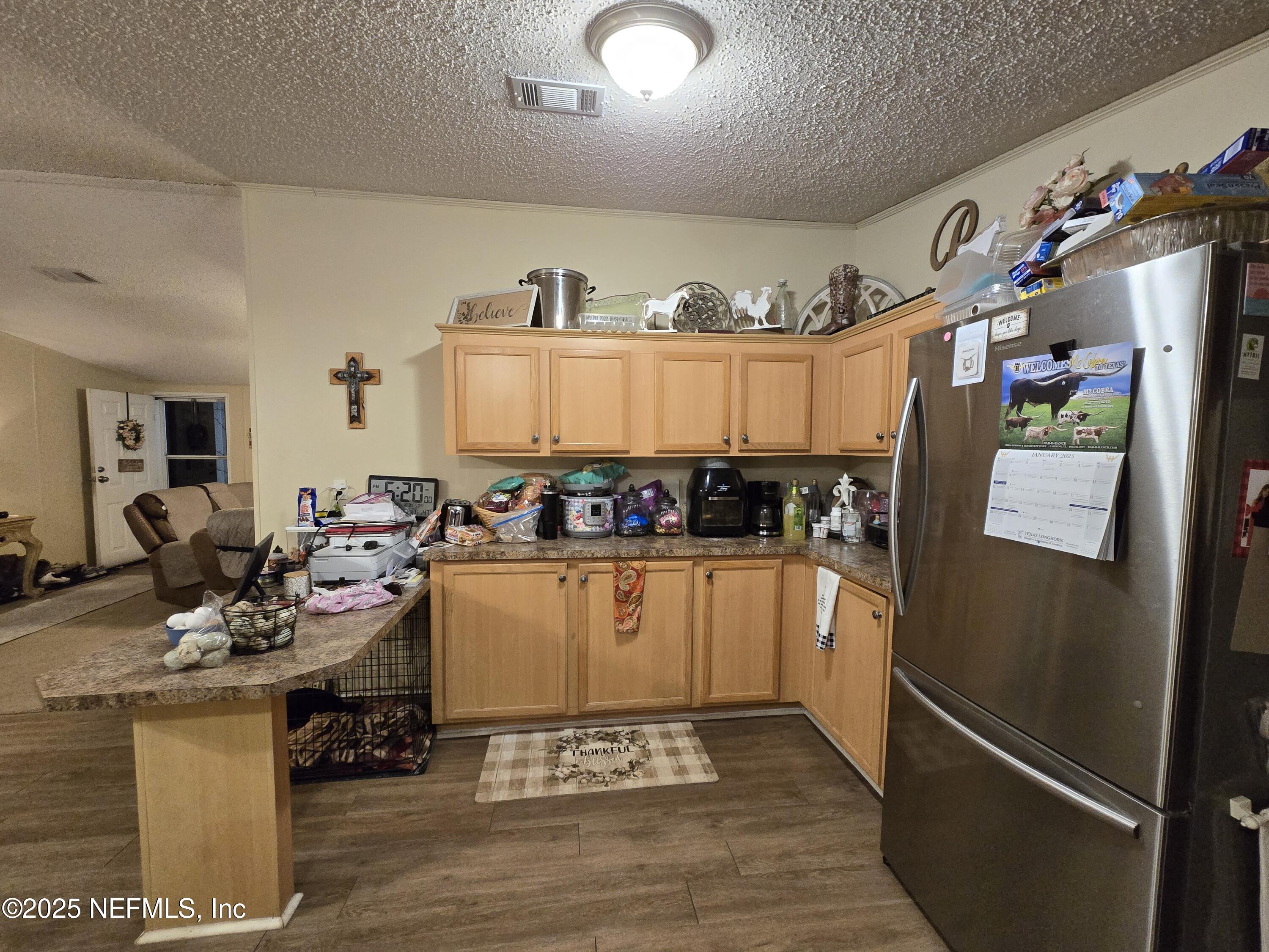 85050 Myrtice Road Yulee, FL 32097 - Photo 18 of 87 a kitchen with a refrigerator and a stove