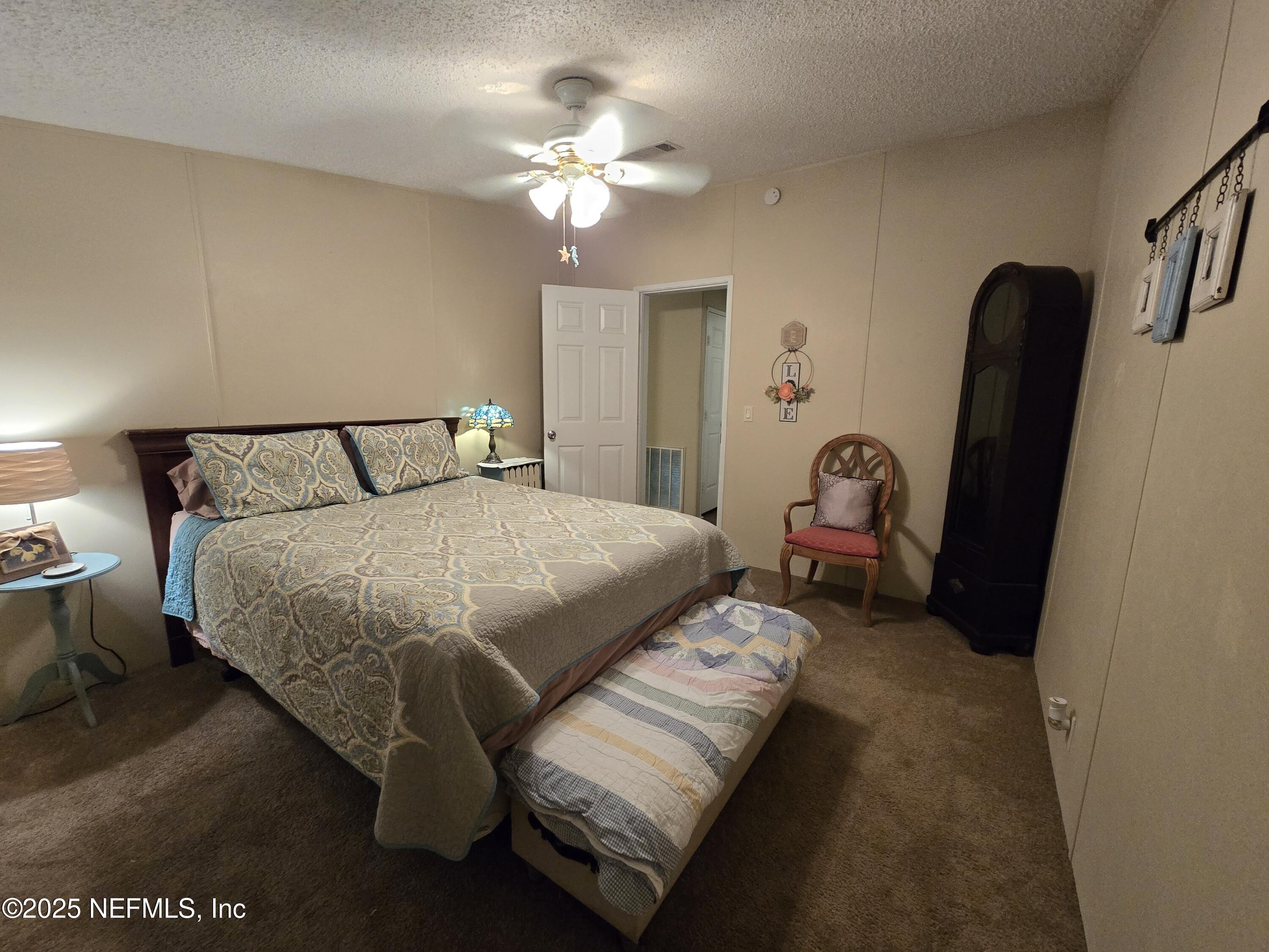 85050 Myrtice Road Yulee, FL 32097 - Photo 24 of 87 a bedroom with a bed a couch and dresser