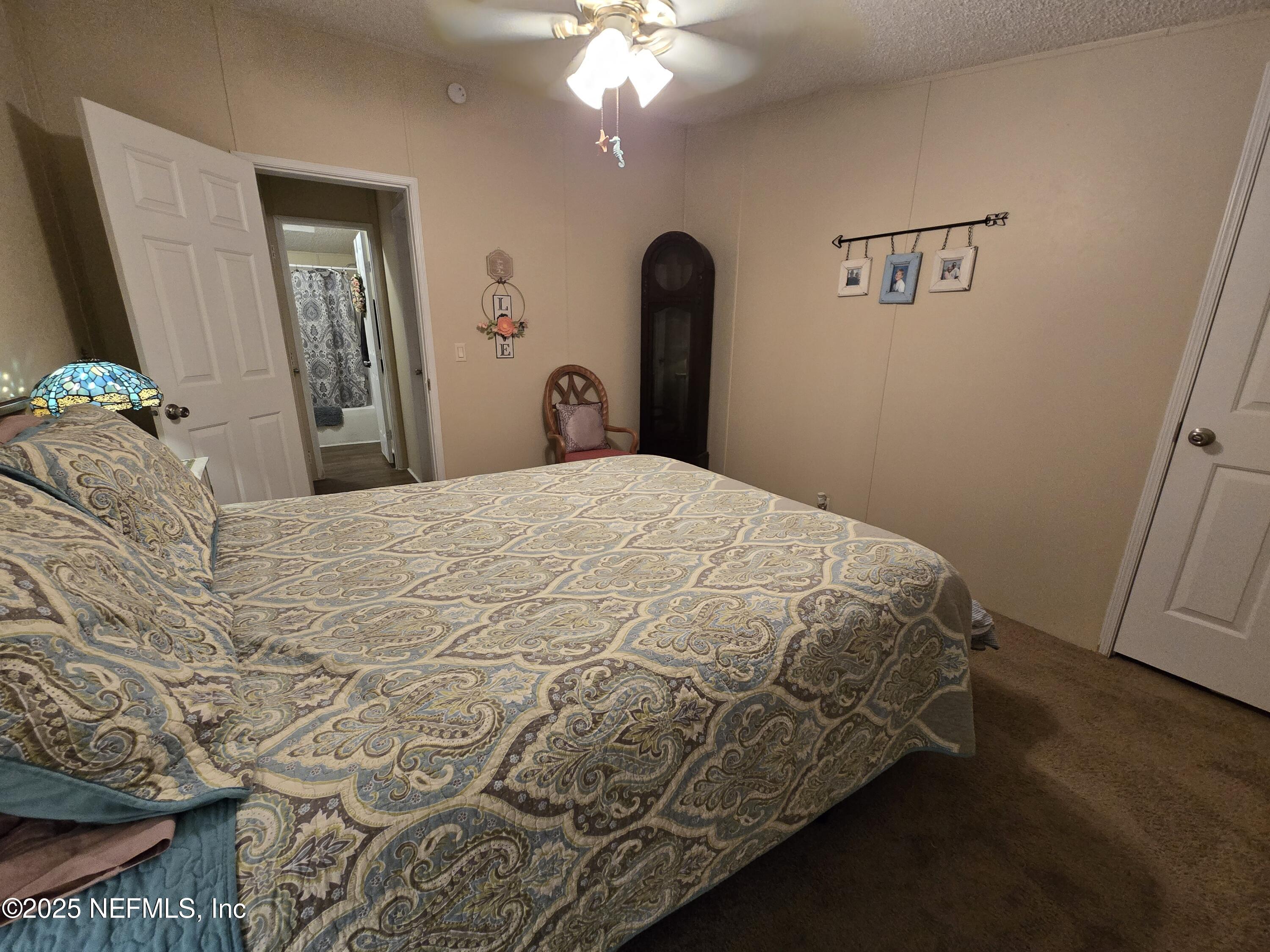 85050 Myrtice Road Yulee, FL 32097 - Photo 25 of 87 a bedroom with a bed and a mirror