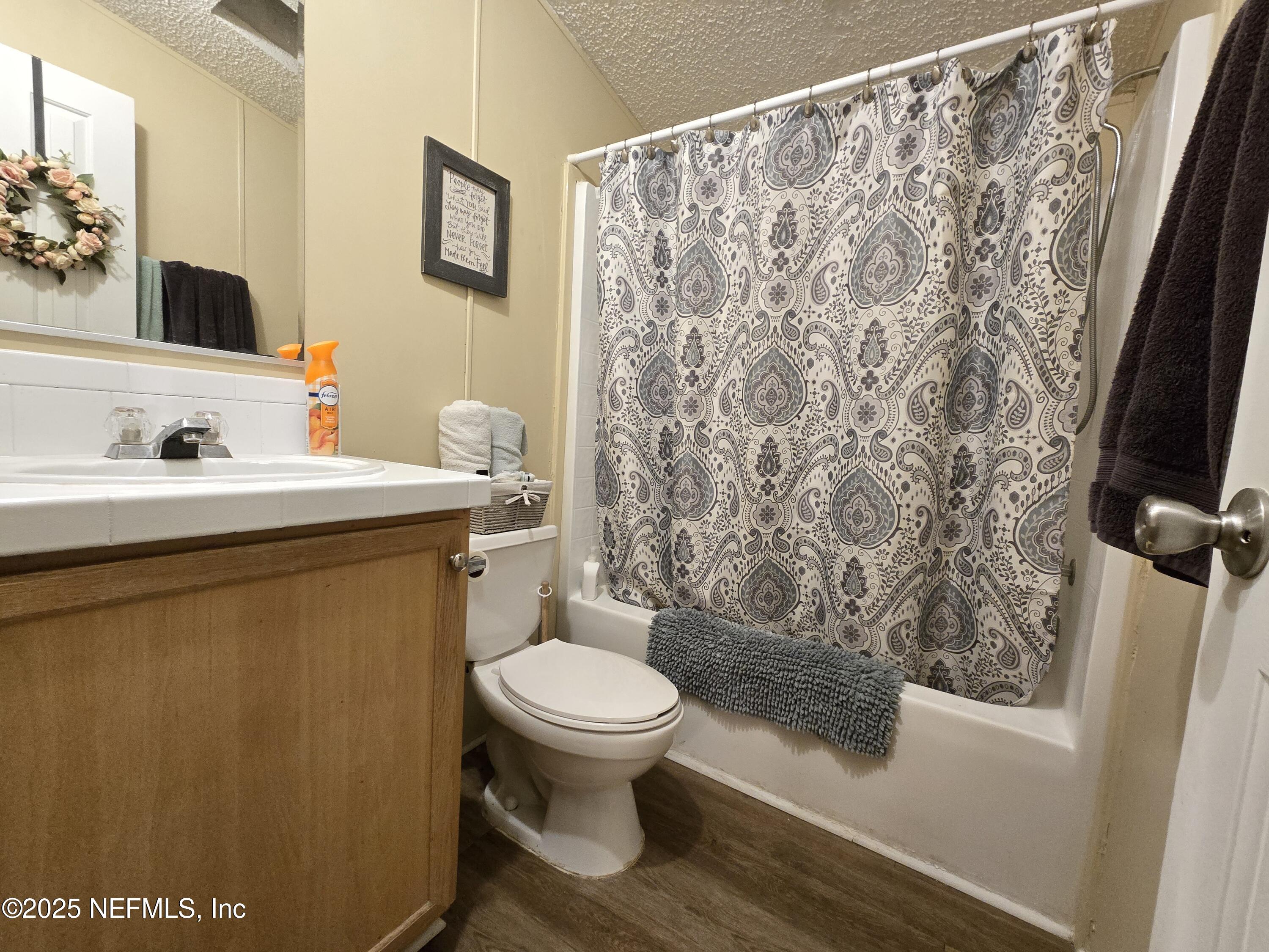 85050 Myrtice Road Yulee, FL 32097 - Photo 26 of 87 a bathroom with a sink toilet and shower