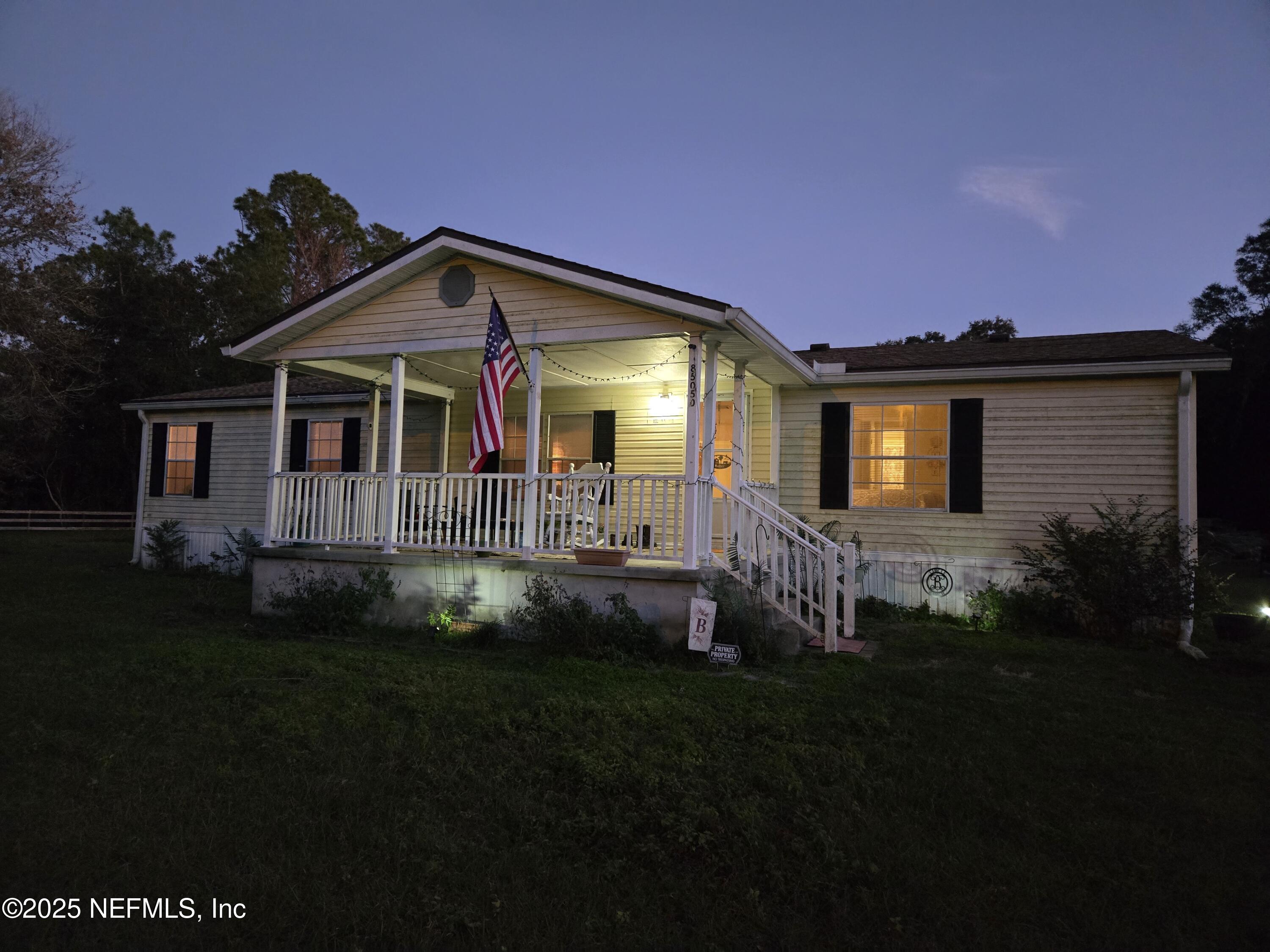 85050 Myrtice Road Yulee, FL 32097 - Photo 87 of 87 a front view of a house with a garden and yard