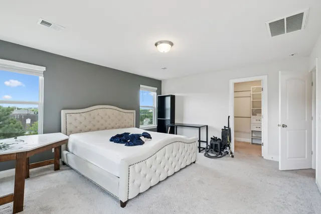 a bedroom with a bed and a table