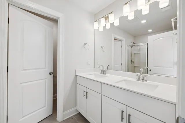 a bathroom with a sink double vanity and a mirror